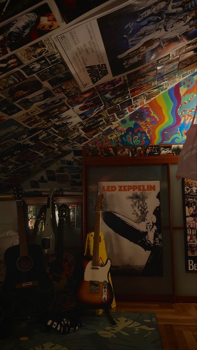 a room filled with guitars and posters on the ceiling