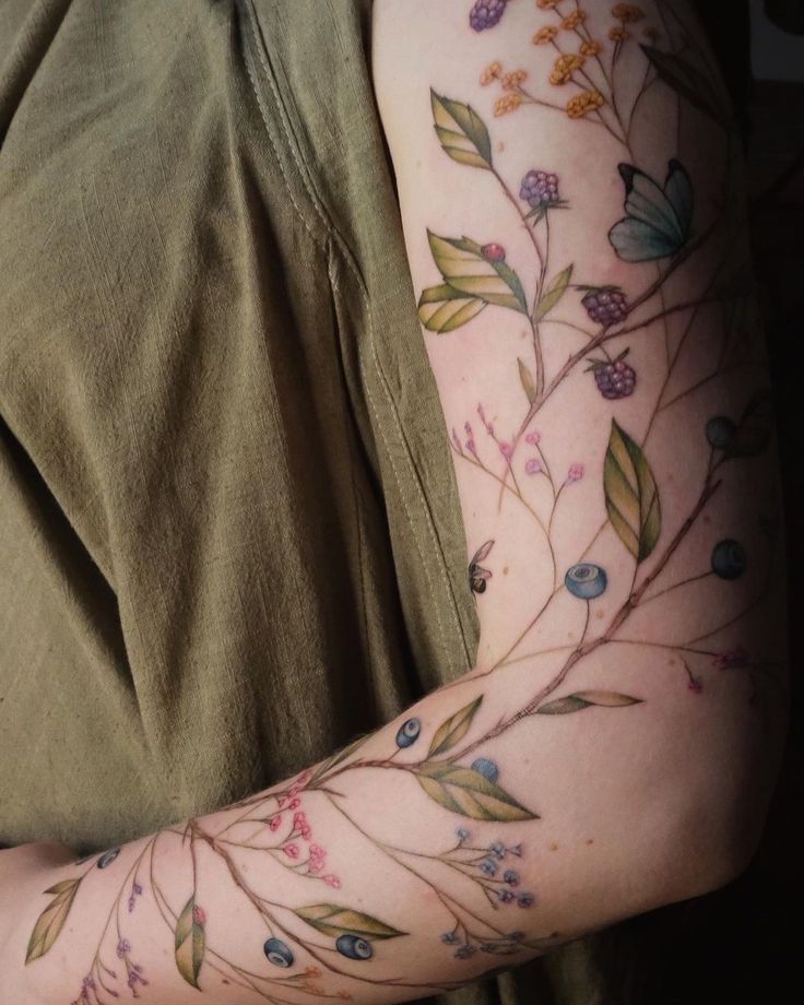 a person with tattoos on their arms and arm