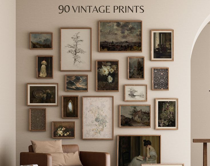 a living room filled with lots of framed pictures on the wall above a chair and table