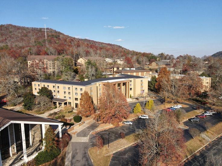 an aerial view of a large building surrounded by trees