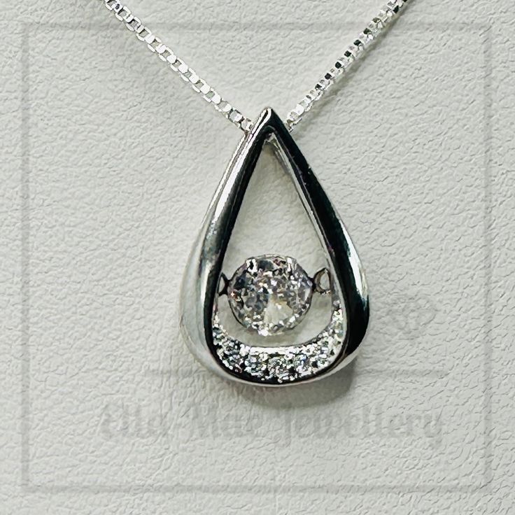 Indulge in luxury with our crystal water drop pendant. The elegant pendant with suspended cubic zirconia exudes sophistication and elegance. Finished off with a subtle silver box chain, this necklace will add a touch of class to any outfit, This tasteful and timeless piece will be a great addition to your jewellery collection.   * 925 Sterling Silver pendant  * Cubic Zirconia   * Pendant size: 1.0 x 1.7 cm  * 18 (45cm) inch strong box chain   * Sturdy lobster clasp  * Comes in luxury gift pouch Elegant Cubic Zirconia Teardrop Solitaire Necklace, Elegant Cubic Zirconia Solitaire Teardrop Necklace, Silver Teardrop Solitaire Necklace, Elegant Silver Solitaire Teardrop Pendant Necklace, Silver Drop Solitaire Necklace For Formal Occasions, Formal Silver Drop Solitaire Necklace, White Gold Pendant Drop Necklace With Cubic Zirconia, White Gold Cubic Zirconia Pendant Drop Necklace, Formal Silver Diamond Necklace With Teardrop Pendant