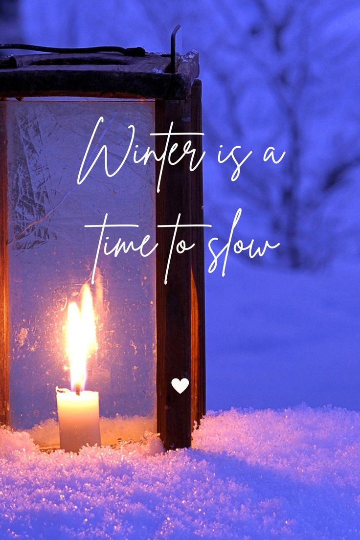 a candle is lit in the snow with words written on it that read winter is a time to slow