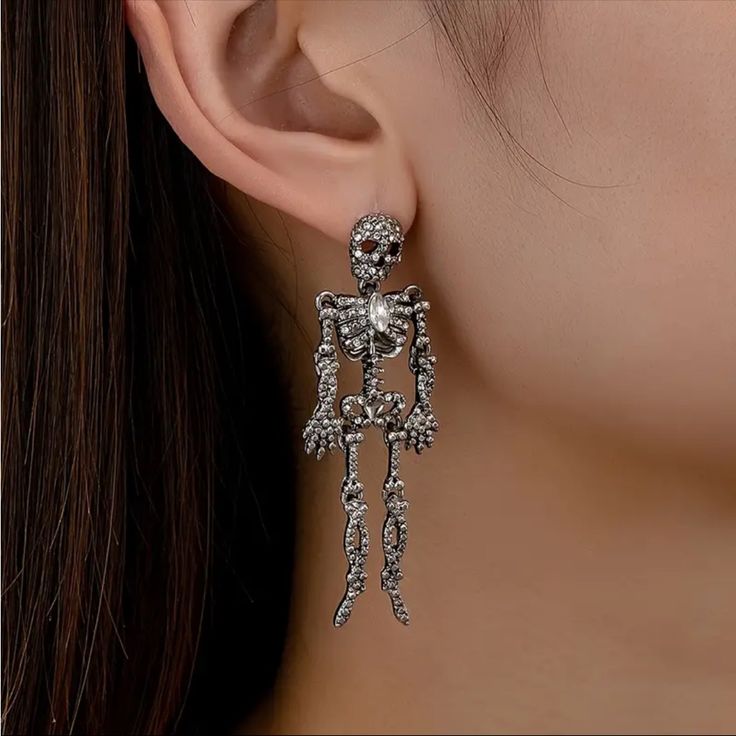 New In Package Color: Silver Rhinestone Skeleton Earrings, Rhinestone Skull Earrings, Halloween Earrings Punk Skull Earrings For Party, Skull-shaped Metal Earrings, Gothic Skull Earrings For Party, Nickel-free Skull Jewelry For Party, Silver Skull Earrings For Halloween, Metal Skull Single Earring, Silver Skull Shaped Single Earring, Elegant Metal Halloween Earrings, Elegant Metal Earrings For Halloween