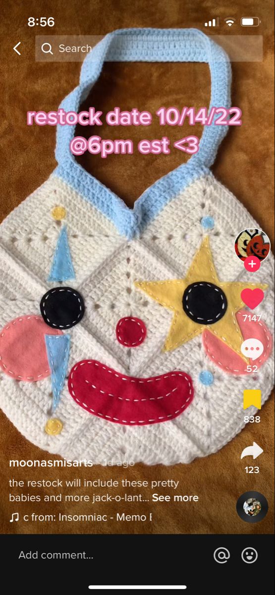 a crocheted bag with an image of a clown's face on it