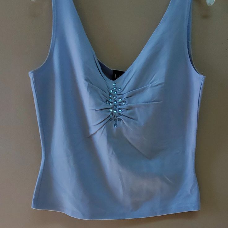 Blue Stretch Tank With Blue Jewels At The Neckline Underarm Across The Front 19 Length Underarm 12 Strap 1" Elegant Blue Tank Top For Spring, Elegant Blue Spring Tank Top, Elegant Blue V-neck Tank Top, Light Blue Tank Top With Built-in Bra For Summer, Blue Tank Top With Built-in Bra, Light Blue Summer Tank Top With Built-in Bra, Blue Stretch Camisole With Built-in Bra, Blue Medium Support Moisture-wicking Tank Top, Cute Pants