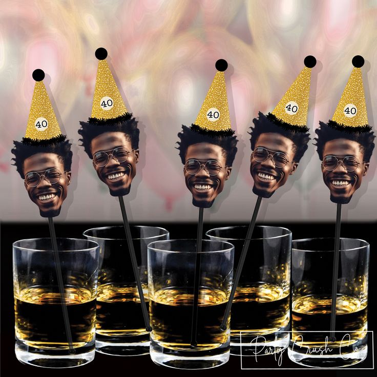 four shot glasses with the faces of three men wearing party hats and holding drinking straws