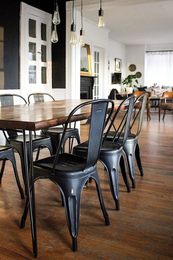 a dining room table and chairs with wood flooring