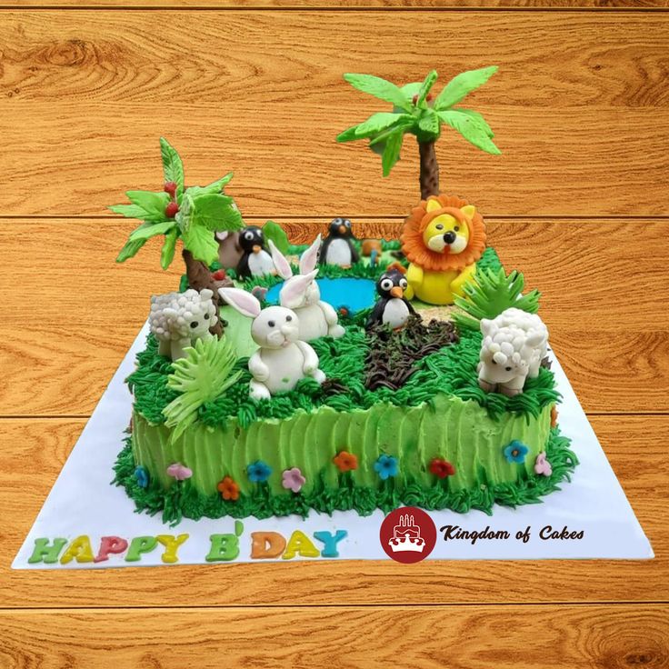 a birthday cake with animals and trees on it