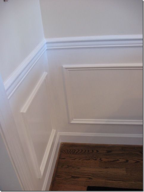 the corner of a room with white walls and wood flooring is painted in an off - white color