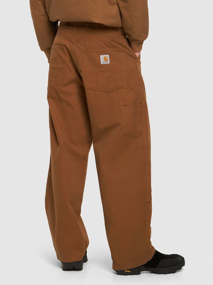 Front button and concealed zip closure. Logo details. Hammer loop. Two front pockets. Two side pockets. Two back pockets. Model is wearing a sizeM Streetwear Bottoms With Welt Pockets And Straight Hem, Streetwear Trousers With Welt Pockets, Classic Pants With Side Pockets For Streetwear, Utility Baggy Bottoms With Welt Pockets, Full Length Pants With Patch Pockets For Work, Classic Brown Bottoms With Patch Pockets, Brown Trousers With Patch Pockets, Wide-leg Streetwear Pants With Welt Pockets, Brown Straight Pants With Patch Pockets