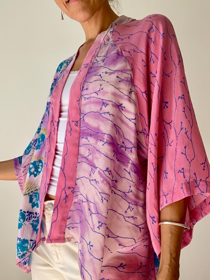 Beautiful and light silk kimono shirt  Delicate semi sheer fabric with delicate prints  Made in one free size in up cycled silk MEAESURE Free size  Shoulder 18" Bust up to 46" Length 33" MATERIAL *vintage silk  More boho style ideas at  https://www.etsy.com/shop/AltheaStores Thank you for looking Pink Printed Open Front Kimono, Pink Open Front Printed Kimono, Pink Batwing Sleeve Top For Summer, Spring Pink Printed Kimono, Spring Silk Kimono With Kimono Sleeves, Floral Print Shawl Kimono For Spring, Spring Floral Print Shawl Kimono, Spring Shawl Kimono With Floral Print, Flowy Long Sleeve Spring Kimono