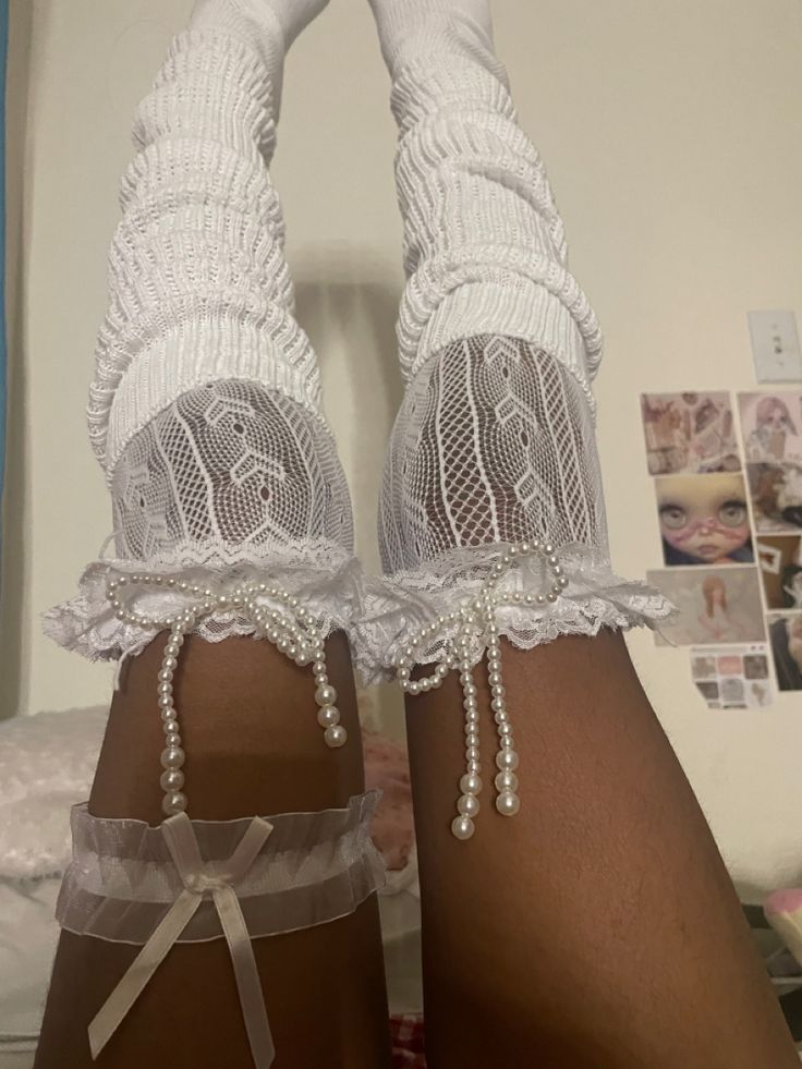 the legs and ankles of a woman wearing white garters