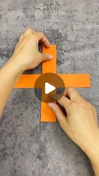 someone cutting out an orange piece of paper