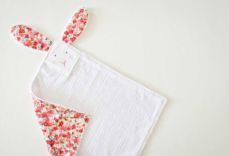 an easter bunny bib and burple bib on a white background with red, pink, blue, green, yellow and orange sprinkles