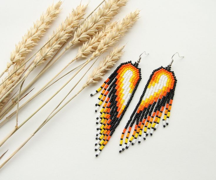 These orange fringe earrings are made using traditional freehand beading techniques. Earrings are made of quality Czech beads and strong thread. You can choose the option of a Hypoallergenic Earring Hooks or 925  silver hooks. Earrings are 11 cm( 4.3 inches) length with hooks and 2.5 cm (1 inche) width. Colors: black,orange,yellow,white. 100% handmade. Don't forget to check out my other jewelry in the store. Maybe you will find exactly what you are looking for. https://www.etsy.com/shop/SandasHa Artisan Orange Round Bead Earrings, Handmade Orange Earrings For Festivals, Handwoven Orange Beaded Earrings For Gift, Handmade Orange Festival Earrings, Handwoven Orange Beaded Earrings As Gift, Artisan Beaded Fringe Earrings As Gift, Artisan Beaded Fringe Earrings For Gifts, Orange Handwoven Dangle Beaded Earrings, Orange Dangle Tassel Earrings For Festival