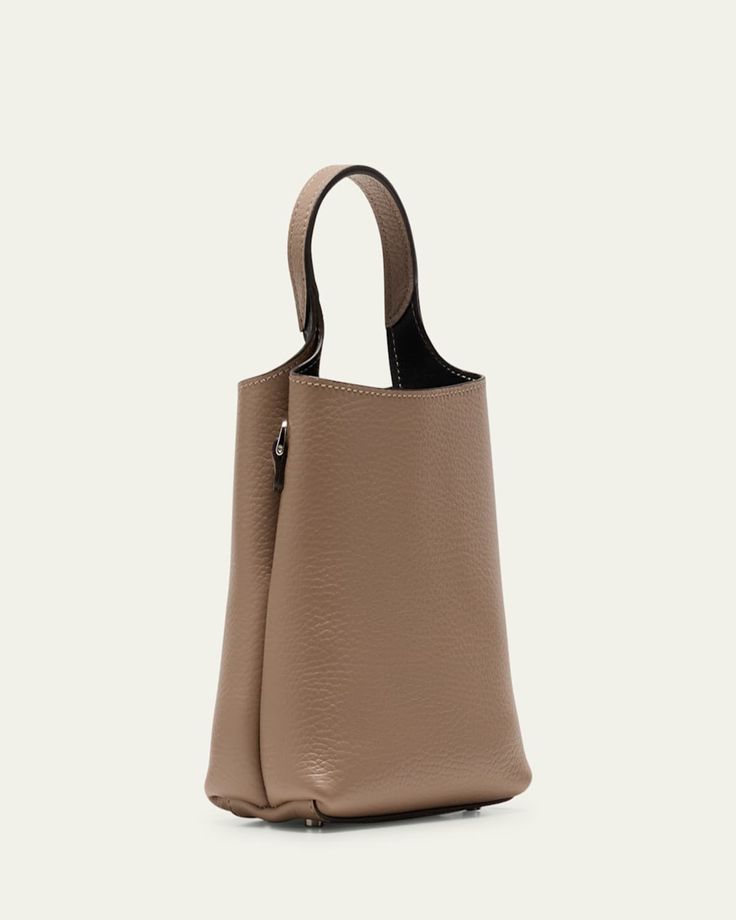 Tod's bucket bag in calf leather     Top handle     Detachable shoulder strap    Can be worn as a top handle or shoulder bag     Open top     Center slip compartment divides interior     Lining: Leather    Feet protect bottom of bag     Approx. 12"H x 12.6"W x 4.7"D    Made in Italy Bucket Satchel With Top Carry Handle For On-the-go, Luxury Leather-handled Bucket Box Bag, Luxury Leather Handle Bucket Box Bag, Luxury Bucket Box Bag With Leather Handles, Luxury Bucket Bag With Top Handle And Removable Pouch, On-the-go Top Handle Bucket Bag, Luxury Bucket Bag With Removable Pouch, On-the-go Bucket Bag With Leather Handles, Luxury Bucket Bag With Handle Drop