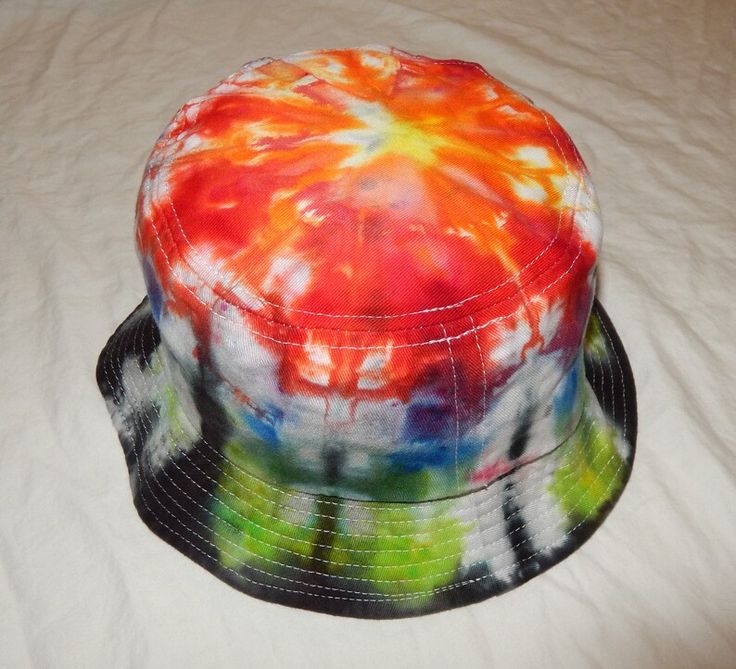 a tie - dyed hat is sitting on a bed