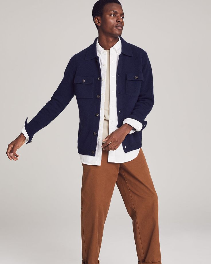 A wardrobe MVP.Crafted from luxuriously knit cashmere, this button-up shirt jacket or “shacket” features two front-flap chest pockets for a classic workwear vibe, a comfortable ribbed hem, and buttoned cuffs that allow you to roll the sleeves up or down with ease. It’s the perfect transitional piece: wear it as outerwear in spring or fall, or layer it up in winter for added warmth. Emblazoned with NOMAD1942’s insignia on the upper left sleeve, this shirt jacket proudly celebrates our New York Ci Collared Sport Coat For Work, Fall Collared Sport Coat With Patch Pockets, Casual Button-up Outerwear With Patch Pockets, Classic Unstructured Collared Utility Jacket, Classic Utility Jacket With Lapel Collar For Business Casual, Collared Utility Jacket With Buttoned Pockets For Winter, Collared Sport Coat With Relaxed Fit For Workwear, Relaxed Fit Collared Sport Coat For Work, Relaxed Fit Outerwear With Patch Pockets For Business Casual