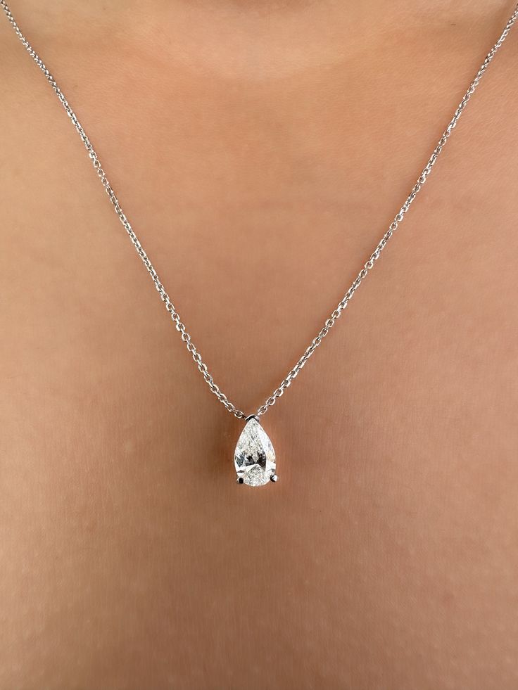 This Beautiful timeless floating diamond pendant is set with a lab-grown pear-shaped diamond in 14k solid gold. The photos show a 0.75ct pear-shaped lab-grown diamond. All of our diamonds are high-quality D color, VS1 clarity. Each diamond is securely set in a Prong setting, radiating sophistication with every glance. Every diamond is expertly positioned to reflect maximum light and brilliance that tells your forever love story. The pendant and chain are made of 14k solid gold and feature a spring clasp. Designed for comfort, this pear diamond necklace can easily be layered with other necklaces. This necklace is sure to bring a smile to her face and become a cherished addition to her jewelry collection. Our collection offers a variety of sizes and carat weights to suit diverse preferences. Timeless Solitaire Teardrop Pendant Necklace With Brilliant Cut, Timeless Solitaire Necklace With Teardrop Brilliant Cut, Formal Diamond Solitaire Necklace With Teardrop Pendant, Timeless Teardrop Solitaire Necklace With Brilliant Cut, Pear-shaped Diamond Necklace With Vvs Clarity For Wedding, Vvs Clarity Pear-shaped Diamond Necklace For Wedding, Timeless Teardrop Pendant Solitaire Necklace With Brilliant Cut, Timeless Pear-shaped Diamond Necklace For Wedding, Formal Teardrop Pendant Solitaire Necklace In Fine Jewelry Style