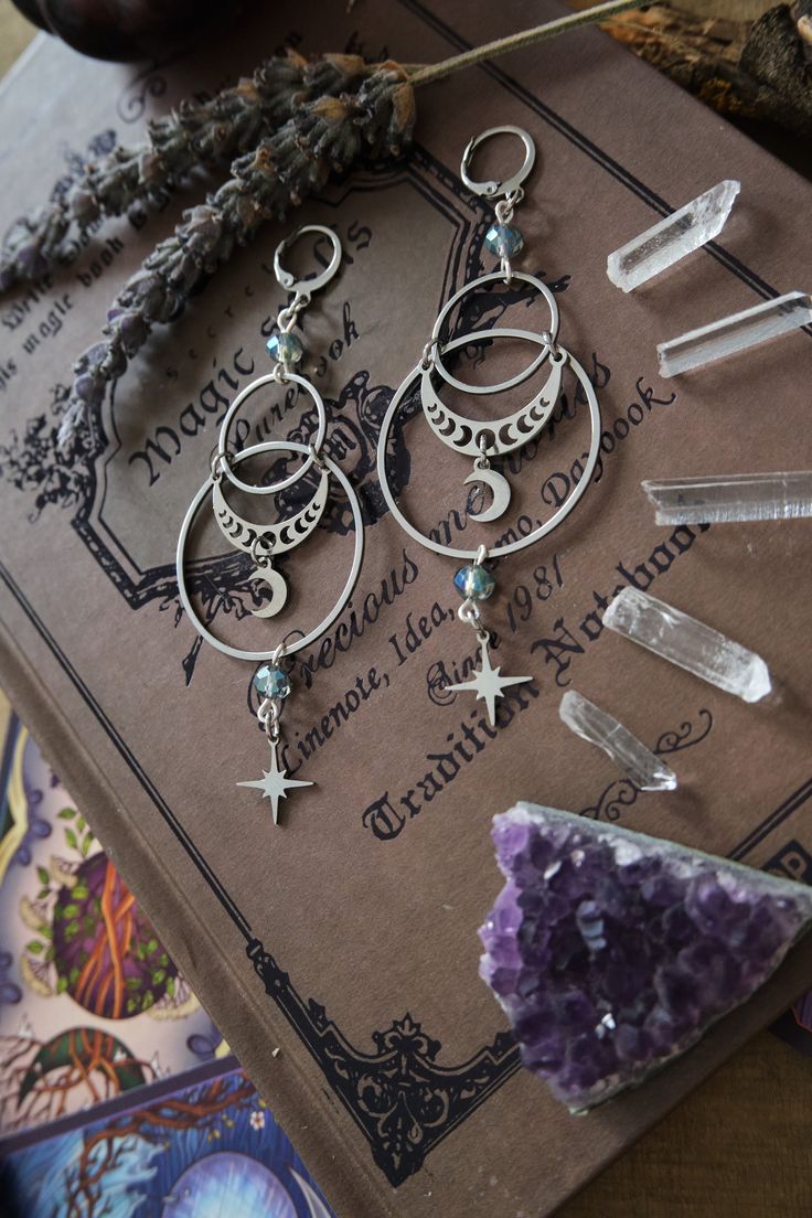 * Stunning statement Moon and Stars earrings which will give your outfit a mystical touch.  * These beautiful dangling earrings have a witchy, bohemian feel to them. * Stainless steel! * The total length of the earrings is approximately 10 cm (aprox 4 inches), hook included.  * They come in a pretty little burlap pouch 🖤 Moon Phase Earing Jewelry, Witchy Jewelry Bohemian, Wiccan Jewelry Hippie, Wiccan Jewelry Bohemian, Wiccan Jewelry Wiccan Place, Affordable Black Witchy Jewelry, Cheap Witchy Halloween Jewelry, Cheap Witchy Dangle Jewelry, Witchy Jewelry Casual