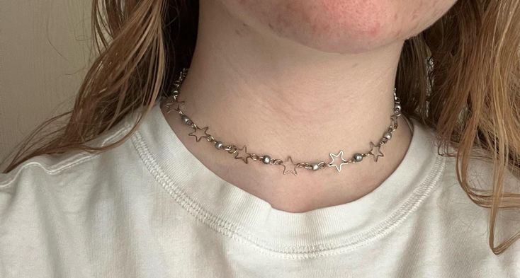 An adjustable celestial choker that is the silver lining to any outfit. Silver Star-shaped Choker For Party, Silver Choker For Summer Festivals, Silver Minimalist Choker For Festivals, Minimalist Silver Choker For Festivals, Casual Silver Star Jewelry, Casual Silver Star-shaped Jewelry, Casual Star-shaped Jewelry For Parties, Casual Silver Necklace For Festival, Dainty Adjustable Metal Choker