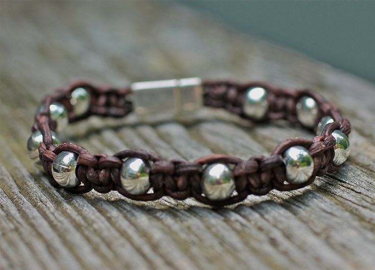 "Brown leather bracelet is tied up with large silver beads. It's a simple and strong unisex fashion statement for women or men. Finished with a strong silver magnetic clasp, it's easy to put on and wear alone or layered up with all your bracelets. For custom size please leave wrist measurement. Return to shop all items: http://www.etsy.com/shop/amyfine ask me anything you like here: http://www.etsy.com/convo_new.php?to_username=amyfine \"OMG I got my jewelry last night and it's AMAZING. I love i Mens Bracelet Designs, Bracelet For Him, Brown Leather Bracelet, Mini Earrings, Bracelet Mens, Silver Bead Bracelet, Bracelet Leather, Braided Leather Bracelet, Bead Bangles