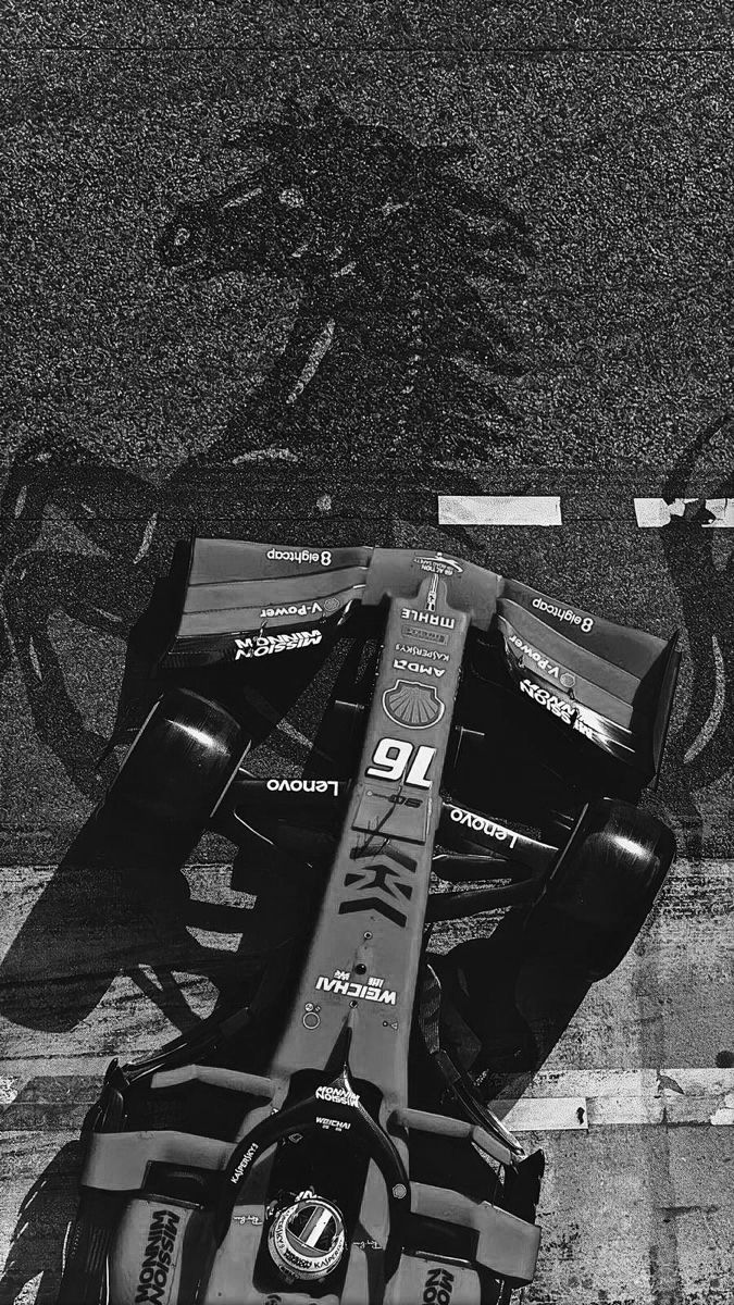 an overhead view of a race car on the ground in front of a bike rack