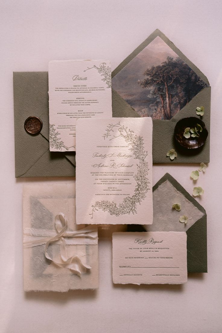 the wedding stationery is laid out on top of each other