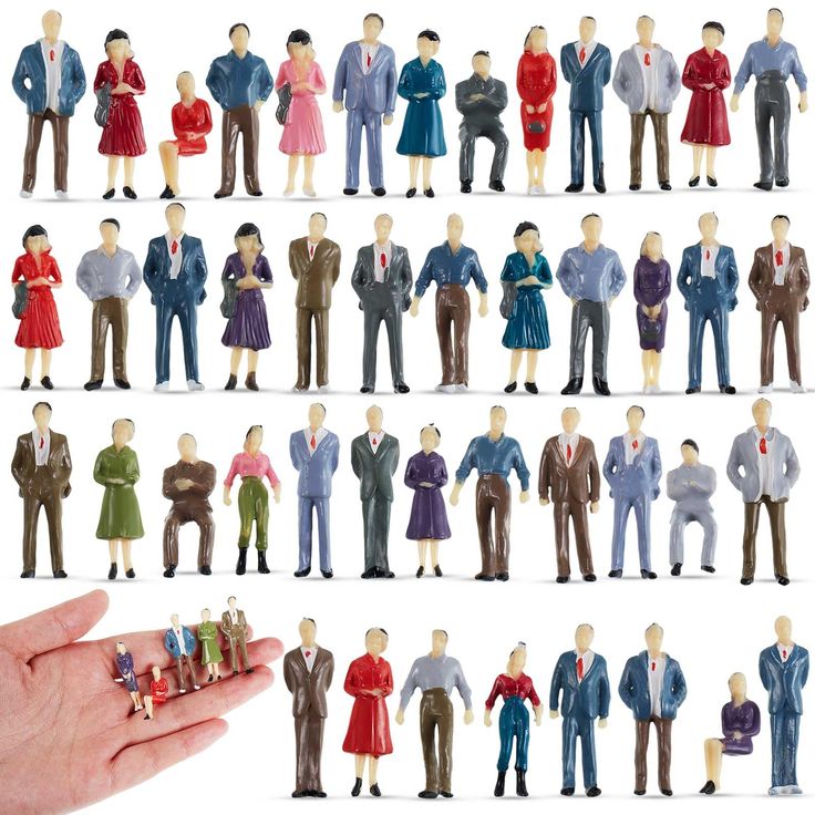 a hand holding a tiny toy figurine with many different people on it's sides