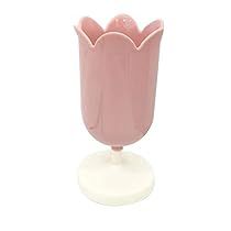 a pink vase sitting on top of a white base