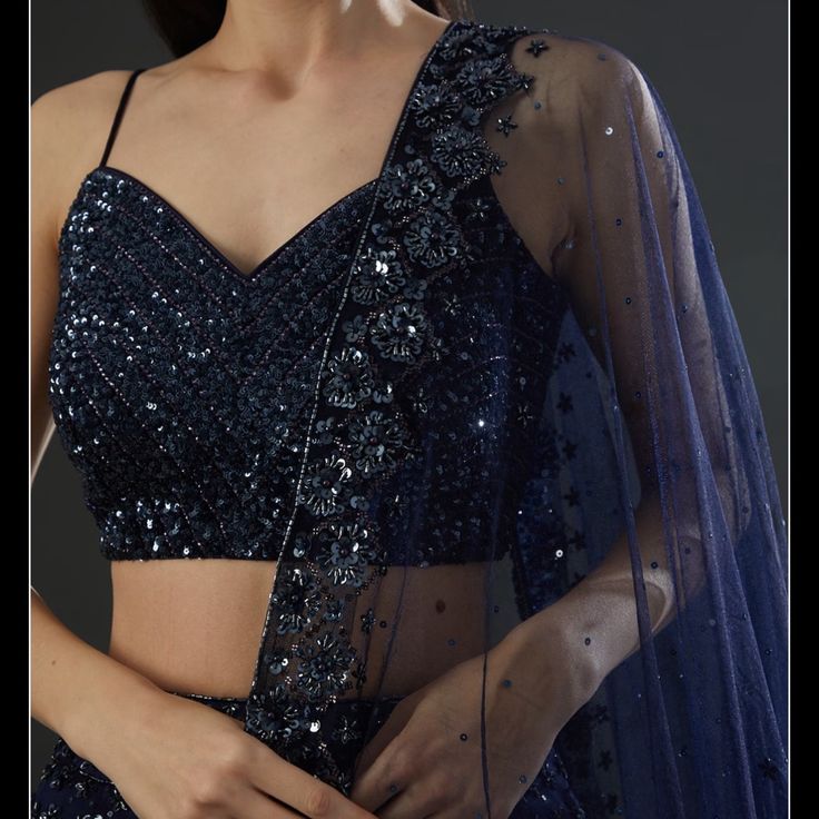 Angad Singh Midnight Blue Organza Embroidered Lehenga Set Size: S(Bust - 34in | Waist - 28in | Hip - 38in) Featuring A Midnight Blue Lehenga In Organza Base With Tonal Sequins, Pipes, Cutdana And Crystal Hand Embroidery. It Is Paired With A Matching Blouse And A Dupatta. Angad Singh Midnight Blue Organza Embroidered Lehenga Set Size: S(Bust - 33in | Waist - 28in | Hip - 38in) Featuring A Midnight Blue Lehenga In Organza Base With Tonal Sequins, Pipes, Cutdana And Crystal Hand Embroidery. It Is P Elegant Blue Lehenga With Sequins, Midnight Blue Lehenga, Elegant Blue Choli With Sequins, Evening Lehenga With Intricate Embroidery On Organza, Blue Embellished Evening Lehenga, Blue Embellished Lehenga For Evening, Embellished Blue Lehenga For Evening, Party Wear Choli With Dupatta For Evening, Blue Sequined Pre-draped Saree For Party