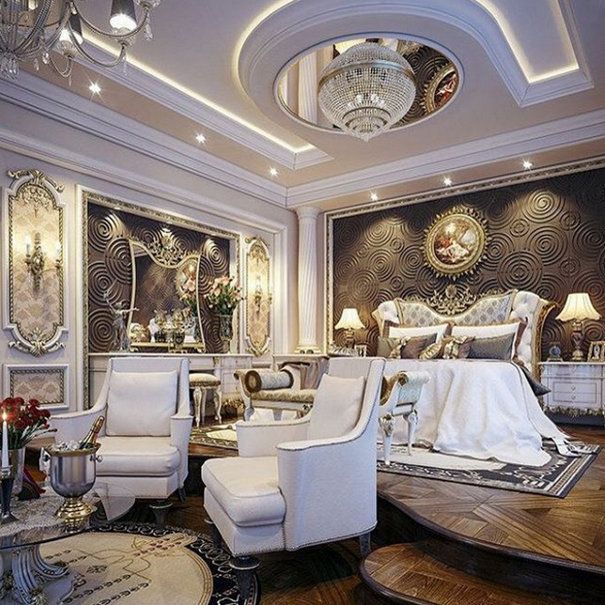 a large bedroom with white furniture and chandelier