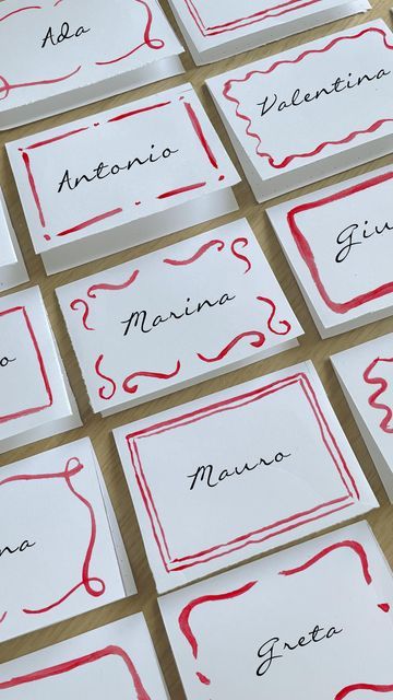 many place cards are lined up on the table for someone to write their name in