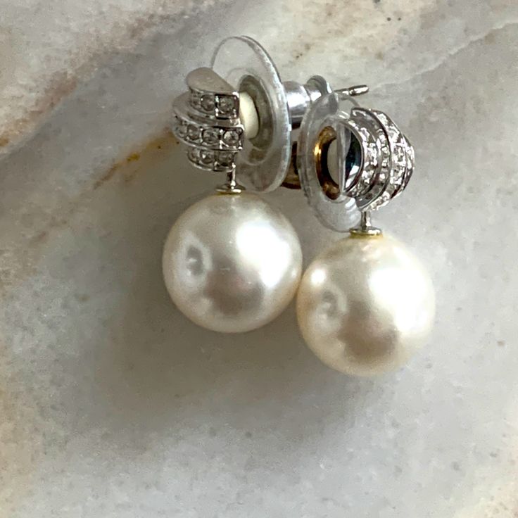 These Classic Pearl Stud Earrings Are An Everyday Essential Classic Formal Pearl Earrings With Pave Setting, White Diamond Pearl Earrings For Formal Occasions, White Diamond Evening Earrings, White Diamond Earrings For Evening, White Diamond Earrings With Pave Setting For Formal Events, Luxury White Earrings With Pave Setting, Luxury White Pearl Earrings With Pave Setting, Luxury White Pave Set Earrings, Elegant Formal Pearl Earrings With Pave Setting