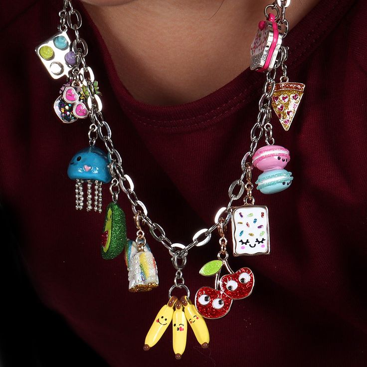 a close up of a person wearing a necklace with charms