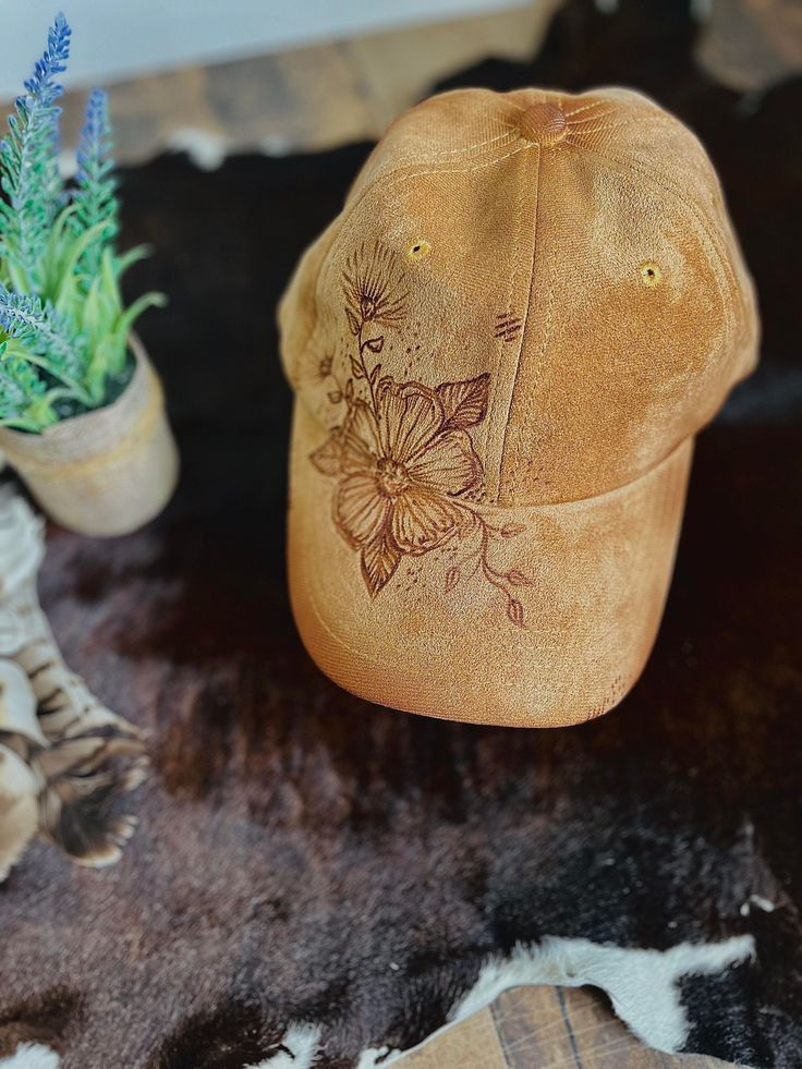 A one-of-a-kind hat, with a unique design hand-burned by our talented artist. Embracing the art of pyrography, this baseball cap is a must-have accessory for any cowboy or cowgirl. Includes an adjustable back strap. We are happy to take custom orders. Please reach out with the design you are looking for!                                                                                          Bundle and save! Do you have a friend or family member who also wants an awesome unique hat? Do you have Adjustable Hand Dyed Hat With Curved Brim, Hand Dyed Adjustable Hat With Curved Brim, Artistic Adjustable Trucker Hat, Distressed Brown Baseball Cap, Vintage Baseball Cap For Festivals, Vintage Festival Baseball Cap, Handmade Adjustable Baseball Cap, Artistic Brown Hats For Festivals, Artistic Brown Hat For Festival