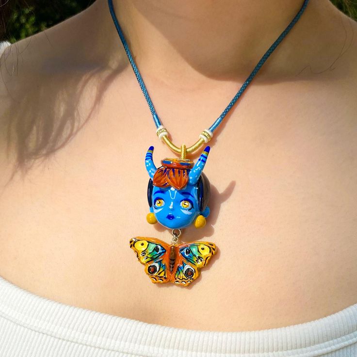 Discover the magic of whimsy with this Unique Face & Butterfly Necklace! Handcrafted from high-quality clay, this enchanting pendant features a beautifully detailed face surrounded by delicate butterfly wings. Perfect for those who love art, nature, and one-of-a-kind jewelry. Key Features: * Handmade craftsmanship that showcases intricate details * Whimsical design ideal for adding a playful touch to any outfit * Versatile accessory for casual wear, special occasions, or festivals * A thoughtful gift for birthdays, holidays, or as a personal treat Usage Scenarios: This necklace is suitable for various occasions, including: * Everyday wear for nature enthusiasts and art lovers * Bohemian festivals, adding flair to your festival outfit * Birthday gifts for friends who appreciate unique, hand Handmade Whimsical Polymer Clay Jewelry, Artistic Handmade Polymer Clay Necklace, Artisan Hand Painted Polymer Clay Necklaces, Artistic Clay Jewelry For Gifts, Handmade Polymer Clay Whimsical Necklaces, Whimsical Handmade Polymer Clay Necklaces, Handmade Clay Jewelry For Crafting, Hand Painted Multicolor Clay Jewelry, Artisan Hand-painted Clay Jewelry