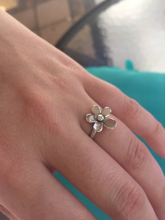 A gorgeous, highly-crafted, sterling silver Daisy Ring. This is a romantic ring with a delicate Daisy/ Plumaria flower on a Sterling silver band. A truly elegant  ring.The Plumaria a flower of ancient India known for its enchanting fragrance, in Hawaii it symbolizes Positivity and to celebrate special occasions. We use the purest 925 sterling silver in all of our designs.  We strive to provide you with a meticulously crafted piece of beautiful jewelry. All of our rings come with a high shine fin Flower Shaped Promise Ring, Flower Shaped Birthstone Promise Ring, Dainty Flower Ring For Anniversary, Dainty Flower Ring With Flower Charm, Delicate Sterling Silver Flower Ring As Gift, Delicate Sterling Silver Flower Ring For Gift, Sterling Silver Delicate Flower Ring Gift, Flower Shaped Promise Ring With Flower Charm, Dainty Daisy Silver Jewelry