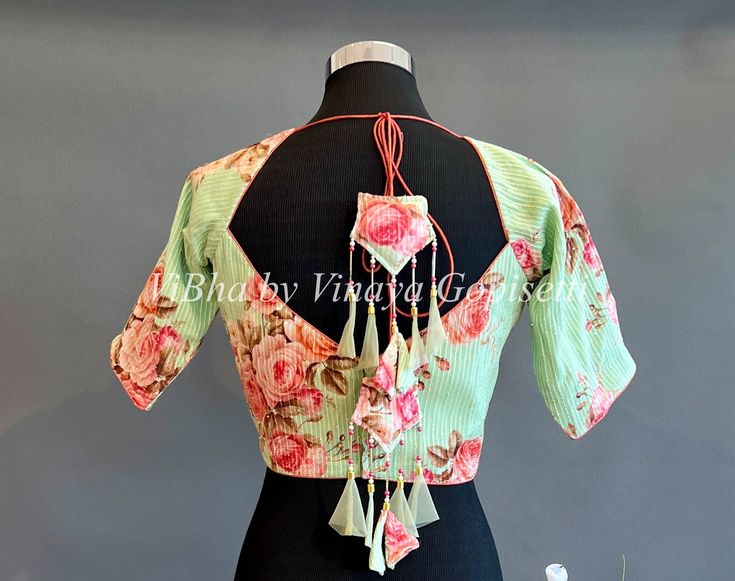 Green Floral Blouse This beautiful green floral blouse is perfect for any special occasion. Crafted from a lightweight material, it features a short sleeve design and a flattering v-neck with a ruffled detail. Put the finishing touches on your look with this stylish and timeless blouse. Blouse size: 38 All the Blouses have enough room to adjust to next two sizes above or below the standard size. Short Sleeve Blouse For Summer Festive Occasion, Summer Festive Short Sleeve Blouse, Spring V-neck Unstitched Blouse, Green Blouse Piece For Spring, Unstitched V-neck Blouse Piece For Spring, Festive Summer V-neck Blouse, Summer V-neck Blouse Piece, Short Sleeve Unstitched Summer Blouse, Green V-neck Festive Blouse