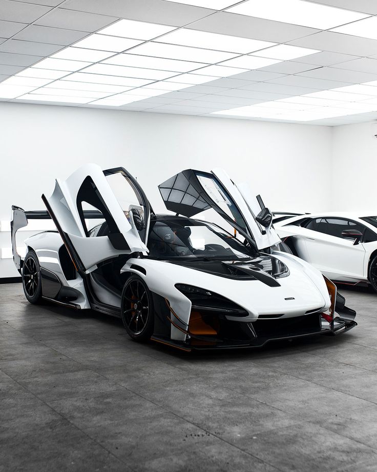 three white and black sports cars in a room