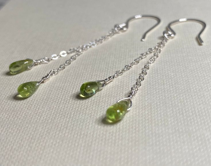 These earrings feature four peridot drops measuring approximately 4-6mm. Metal components are sterling silver, with sparkling .925 sterling silver chain and hammered sterling silver ear wires (made in the USA). These earrings are handcrafted and made to order. Features: -Peridot: Believed by some to promote growth, independence, love and abundance. *Images are for illustrative purposes only. Each stone is unique and may vary from what is pictured in color, opacity, etc. Details: -Materials: Ster Nickel-free Round Peridot Earrings, Nickel Free Peridot Jewelry, Green Peridot Drop Earrings, Nickel-free Peridot Round Jewelry, Nickel-free Peridot Elegant Jewelry, Lime Green Sterling Silver Birthstone Jewelry, Elegant Peridot Nickel-free Jewelry, Elegant Nickel-free Peridot Jewelry, Handmade Peridot Round Earrings