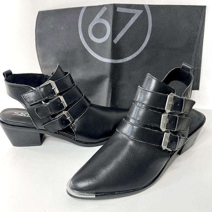 The Sixtyseven 78551 Napa Black Leather Pointed Ankle Booties ***Brand New // Never Used*** Silver Metal Trims The Pointed Toe Of These Genuine Leather Booties With Gunmetal Buckles At The Outstep, And A Cutaway Heel. ->Color: Black ->2.25" Stacked Block Heel. ->3.5" Zipper At The Instep. ->Cushioned Insole. ->Nonskid Rubber Sole. ***Shoe Dustbag Included*** These Booties Are Nice To Dress Up Or Down, They Are A Little Bit Country And Little Bit Rock And Roll! Silver Metal Trims The Pointed Toe Trendy Boots With Buckle Closure And Low Heel, Edgy Ankle-high Spring Booties, Trendy Low Heel Boots With Buckle Closure, Trendy Closed Toe Boots With Buckle Closure, Edgy Spring Ankle-high Booties, Spring Edgy Ankle-high Booties, Casual Pointed Toe Heels With Buckle Closure, Casual Pointed Toe Heels With Buckle, Pointed Toe Booties With Buckle Closure