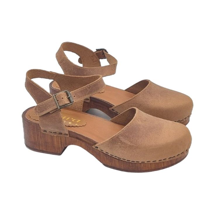 Buy now our handmade clogs in Italy: a timeless classic model that combines comfort and style, made using top quality products. Swedish style clogs with brown wood effect base Upper in hazelnut colour Closed rounded tip Adjustable strap at the ankle Footbed in padded leather Heel height 4 cm with 2 cm platform Made entirely by specialized Italian staff  Handmade using the best materials. BEFORE COMPLETING THE PURCHASE, DO NOT FORGET TO CHECK THE SIZE! --- This handmade article is made and design Brown Wooden Open Heel Clogs, Natural Wood Round Toe Clogs, Natural Clogs With Removable Insole And Open Heel, Brown Open Toe Clogs With Cork-bed Midsoles, Closed Toe Natural Clogs With Rubber Sole, Natural Color Closed Toe Clogs With Rubber Sole, Brown Closed Toe Clogs With Removable Insole, Brown Open Heel Clogs With Rubber Sole, Natural Closed Toe Clogs With Rubber Sole