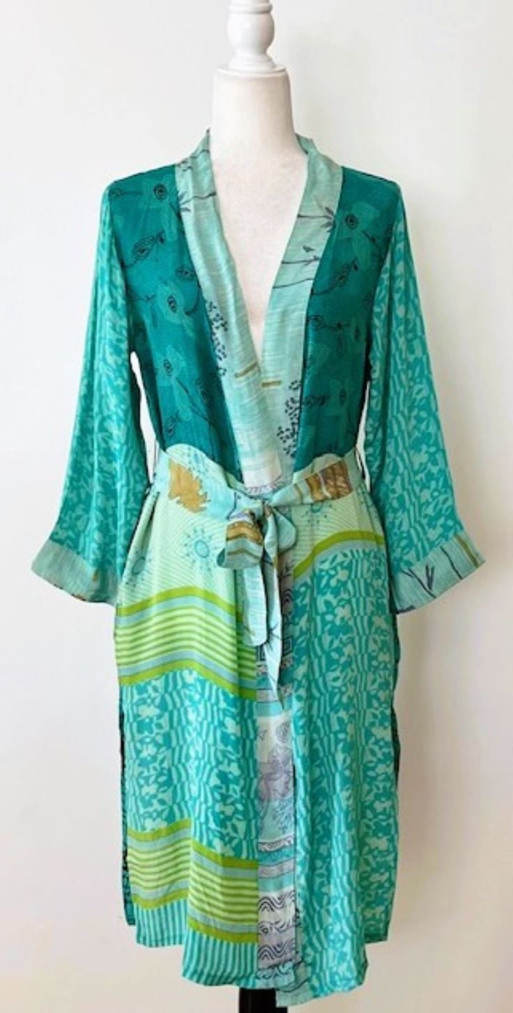 Luxury Silk Kimono Duster: Elegant. This Kimono has a beautiful finish, printed on a classic pattern. Creates depth, interest, and designer appeal. Luxurious fabric, soft, opaque. The perfect duster for cocktail parties, resort, beach or poolside cover-up. Adapts well to a duster coat or dress. A stunning mix of deep contrasting colors, turquoise, black, emerald, etc. . Great gift for the Holidays, Valentine's Day, Mother's Day, Birthday, or just because you deserve it. Fabric is soft and drapes Summer Silk Dresses With Open Front, Silk Open Front Summer Dress, Green Spring Vacation Robe, Spring Vacation Green Robe, Green Printed V-neck Kimono, Spring Open Front Silk Dress, Fitted Green Kimono For Summer, Fitted Green Spring Kimono, Green Long Sleeve Summer Robe