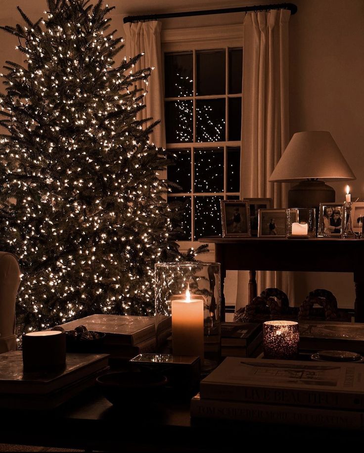 a living room with a lit christmas tree in the corner