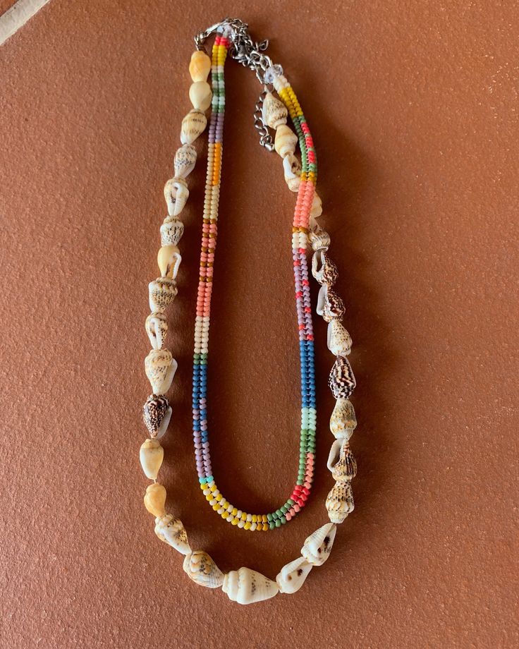 Summer Vibes 100% 👙☀️🕶️ Tutti Frutti Gelato 🍧 || Handwoven Beaded Necklace + Shell Necklace 🐚 . . #endlesssummer #handmadenecklace #beadednecklace #handwovenjewelry #beadedjewelry #colliers #colliersurfeur #beachjewelry #beachnecklace #necklaceshop #beadedchoker #surfernecklace #beachyjewelry #papsatelier #shellnecklace Multicolor Tiny Beads Strand, Multicolor Multi-strand Beads For Beach, Multicolor Multi-strand Beach Beads, Multicolor Beaded Chain Strand Beads, Bohemian Multicolor Heart Beads Necklace, Multicolor Beaded Strand Shell Necklace, Multicolor Strand Shell Necklace, Multicolor Multi-strand Beaded Necklaces For Beach, Multicolor Beaded Shell Necklace Strand