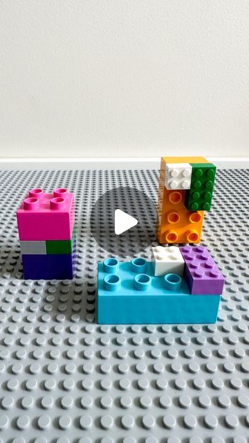 three legos sitting on top of a floor next to each other in different colors