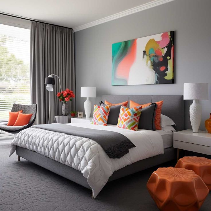 a bedroom with gray walls and orange accents