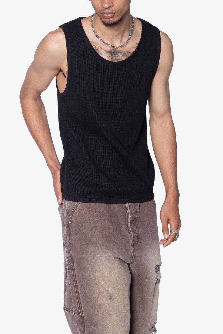 the Waffle Knit Tank is a 100% cotton tank is perfect as a base layer or worn alone. the tank features taping at the neck and arm openings, a flat hem, and is constructed in a ribbed material. details flat hem 100% ribbed cotton fabric Model is 6’0, 140 lbs and wears a size medium Black Tank Top With Ribbed Neckline For Summer, Black Ribbed Neckline Tank Top For Summer, Black Sleeveless Top With Ribbed Neckline, Urban Crew Neck Cotton Tank Top, Urban Cotton Crew Neck Tank Top, Urban Style Cotton Crew Neck Tank Top, Casual Cotton Ribbed Tank Top, Casual Ribbed Cotton Tank Top, Black Ribbed Cotton Tank Top