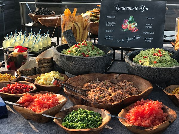 an assortment of food is on display for sale at a buffet table with signs in the background